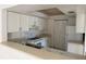 Kitchen featuring white cabinets, laminate countertops, white appliances, and a large pantry at 2562 Lakeway Branch Way # 3002, Orlando, FL 32839