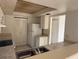Functional kitchen with stainless steel sink, white cabinets, and appliances at 2562 Lakeway Branch Way # 3002, Orlando, FL 32839