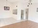 Spacious living room with tile and hardwood flooring, neutral paint, and view into the white kitchen at 2562 Lakeway Branch Way # 3002, Orlando, FL 32839