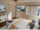 Bright main bedroom featuring a closet, window with blinds, and a television on the wall at 2562 Lakeway Branch Way # 3002, Orlando, FL 32839