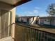 Balcony view of multi-Gathering residential complex with manicured lawns under a blue sky at 2562 Lakeway Branch Way # 3002, Orlando, FL 32839