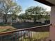 Balcony view overlooking community green space and mature trees from the porch at 2562 Lakeway Branch Way # 3002, Orlando, FL 32839