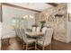 Elegant dining room features a large table, upholstered chairs, brick accent wall and natural lighting at 2600 Robie Ave, Mount Dora, FL 32757
