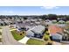 Charming neighborhood showcasing well-maintained homes, manicured lawns, and vibrant landscaping at 2606 Olivarez Way, The Villages, FL 32162