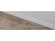 Close up of new baseboard installation with wood flooring at 2606 Olivarez Way, The Villages, FL 32162