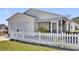 Charming single-story home with a well-manicured lawn and white picket fence at 2606 Olivarez Way, The Villages, FL 32162