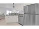 Modern kitchen featuring stainless steel appliances, ample counter space, and stylish lighting at 2606 Olivarez Way, The Villages, FL 32162