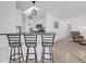 Bright kitchen with modern appliances, breakfast bar, and stylish pendant lighting at 2606 Olivarez Way, The Villages, FL 32162