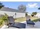 Outdoor patio with comfortable lounge chairs and manicured landscaping at 2606 Olivarez Way, The Villages, FL 32162