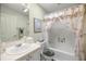 Bathroom featuring a shower with seashell shower curtain, sink and seashell-themed decor at 2738 Privada Dr, The Villages, FL 32162
