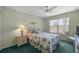 Cozy bedroom features a floral comforter, a window and a ceiling fan at 2738 Privada Dr, The Villages, FL 32162