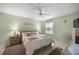 Cozy bedroom with a ceiling fan, neutral walls, and a view of the exterior at 2738 Privada Dr, The Villages, FL 32162