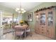 Cozy dining area with a view of sliding glass doors to the lanai and a decorative cabinet at 2738 Privada Dr, The Villages, FL 32162