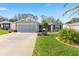 Charming single-story home features a manicured lawn, two-car garage, and welcoming curb appeal at 2738 Privada Dr, The Villages, FL 32162