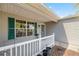 Inviting front porch with decorative railings and a view of the well-maintained exterior at 2738 Privada Dr, The Villages, FL 32162