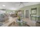 Open-concept living room with tile flooring, neutral walls, and a view into the dining area at 2738 Privada Dr, The Villages, FL 32162