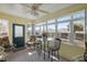 Bright sunroom with tile floors, dining set, ceiling fan and multiple windows offering views at 2738 Privada Dr, The Villages, FL 32162