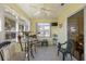 Bright sunroom featuring tile floors, large windows, a ceiling fan, and a glass top table at 2738 Privada Dr, The Villages, FL 32162