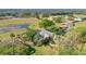 Wide angle aerial view of a house surrounded by trees, lawns, and a pond at 2746 Park Royal Dr, Windermere, FL 34786