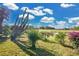 Expansive backyard view with lush landscaping, mature trees, and a distant view of the golf course at 2746 Park Royal Dr, Windermere, FL 34786