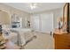 Bright bedroom features two closets, ceiling fan and a light gray rug at 2746 Park Royal Dr, Windermere, FL 34786