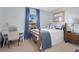 Bedroom with blue accents, desk, and a bedside table with lamp at 2746 Park Royal Dr, Windermere, FL 34786