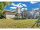 Rear exterior view of the home featuring a screened-in pool and manicured lawn at 2746 Park Royal Dr, Windermere, FL 34786