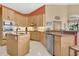 This kitchen boasts stainless steel appliances, custom cabinets, and ample counter space at 2746 Park Royal Dr, Windermere, FL 34786