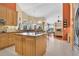 Bright kitchen features an island, granite countertops, stainless steel appliances, and an open view to the living room at 2746 Park Royal Dr, Windermere, FL 34786