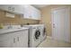 Laundry room with washer, dryer, sink, and ample storage space at 2746 Park Royal Dr, Windermere, FL 34786