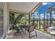 Cozy screened in porch with dining area and views of the green landscape at 2746 Park Royal Dr, Windermere, FL 34786