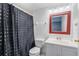 Bathroom with a white vanity and a shower with a polka dot curtain at 3011 George Mason Ave # 3, Winter Park, FL 32792