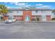 Charming condo with a private parking area, exterior brick accents, and tropical palm tree at 3011 George Mason Ave # 3, Winter Park, FL 32792