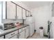 Bright kitchen features white cabinetry, modern appliances, and efficient layout at 3011 George Mason Ave # 3, Winter Park, FL 32792