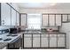 Kitchen features white cabinets with black trim and modern appliances at 3011 George Mason Ave # 3, Winter Park, FL 32792