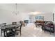 Well-lit living room and dining area with contemporary lighting, large sofa, and a decorative fireplace at 3011 George Mason Ave # 3, Winter Park, FL 32792