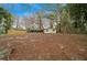 Expansive backyard featuring mature trees, providing ample shade and privacy for outdoor activities at 30713 George Dr, Tavares, FL 32778