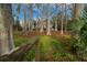 A large backyard with tall trees on land leading to a home at 30713 George Dr, Tavares, FL 32778