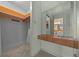 Bathroom with walk-in closet, vanity and mirror, visible toilet and shower area at 30713 George Dr, Tavares, FL 32778