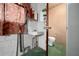 This is a small, functional bathroom with a corner sink, toilet and patterned shower curtain at 30713 George Dr, Tavares, FL 32778
