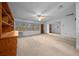 Open living room with natural light and neutral carpet, with adjacent doorways at 30713 George Dr, Tavares, FL 32778
