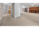 View of the living room featuring neutral carpet and adjacent doorways and passageways at 30713 George Dr, Tavares, FL 32778