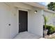 Exterior of unit 311, featuring a well-maintained black front door and painted exterior at 311 Dorchester Sq, Lake Mary, FL 32746