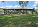 View of large backyard with patio and home's exterior at 3130 Bulkley Pl, Eustis, FL 32726