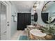 Stylish bathroom with double sinks, black hardware, and a shower with black curtain at 3130 Bulkley Pl, Eustis, FL 32726