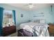 Bright bedroom with beach decor, including oars, light blue walls, and modern ceiling fan at 3130 Bulkley Pl, Eustis, FL 32726
