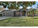 Charming single-story home with a well-manicured lawn, two car garage, and inviting front porch at 3130 Bulkley Pl, Eustis, FL 32726