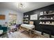 Stylized home office with modern desk, shelving, natural light, and contrasting black and gray wall paint at 3130 Bulkley Pl, Eustis, FL 32726