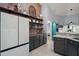 Charming kitchen features custom shelving, brick accent wall, and modern appliances at 3130 Bulkley Pl, Eustis, FL 32726