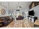 Bright living room featuring wood floors, comfortable seating, and sliding doors to the backyard at 3130 Bulkley Pl, Eustis, FL 32726